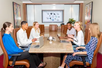 Clients meeting in a fully equipped boardroom with 5-star amenities and premium service.